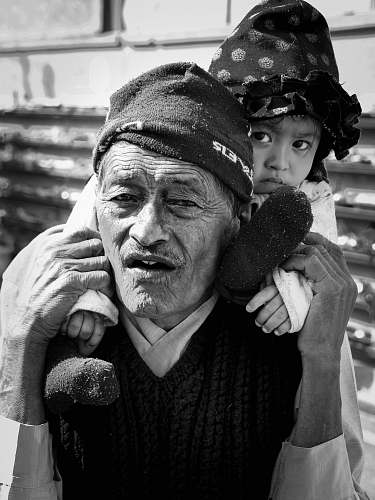 apparel man carrying girl in selective focus photography clothing