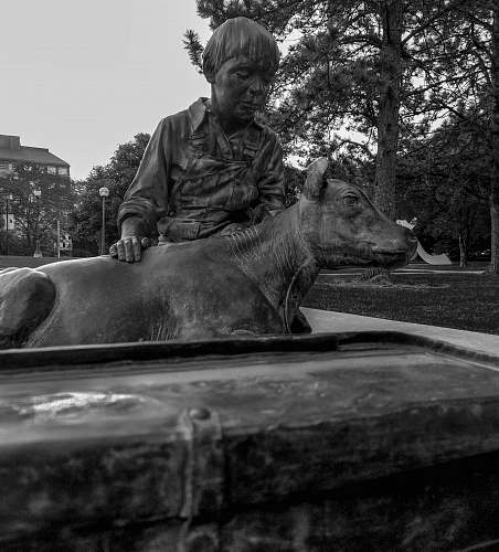 human man holding animal statue person