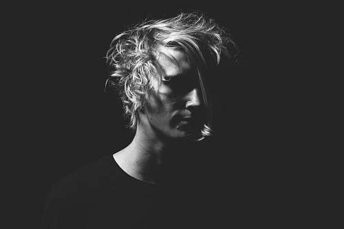 portrait man in black T-shirt in grayscale photography person
