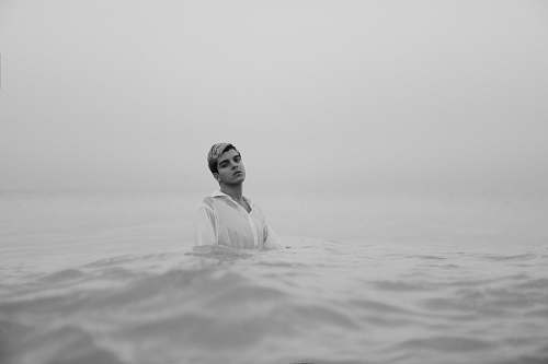 person man in body of water grey