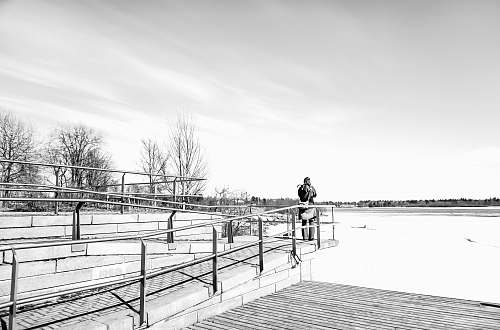 banister man standing beside railings handrail