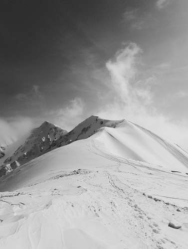 grey mountain coated by snow mountain