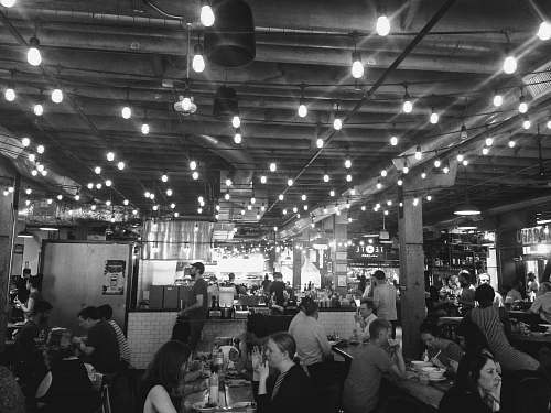 human people sitting and others are standing inside bar and restaurant restaurant