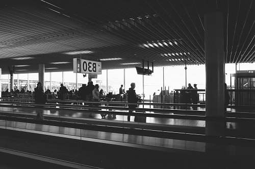 human people standing and walking inside building during daytime airport