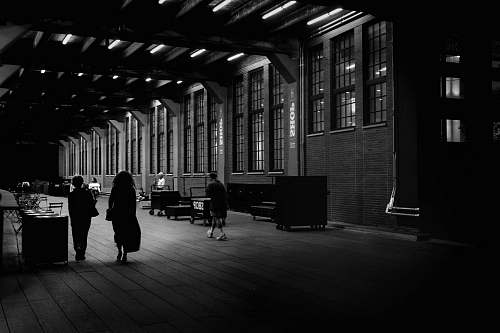 person people walking on pathway near buildings flooring