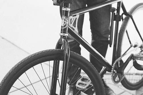 bicycle person beside black road bike bike