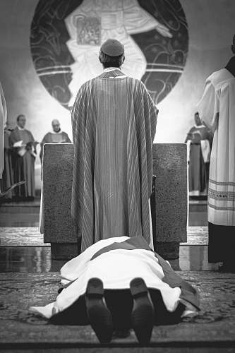 apparel person lying on floor while another man standing beside him clothing