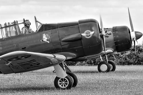 aircraft person riding on jet grayscale photography airplane