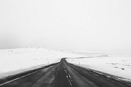 snow photo of asphalt road towards snow field road