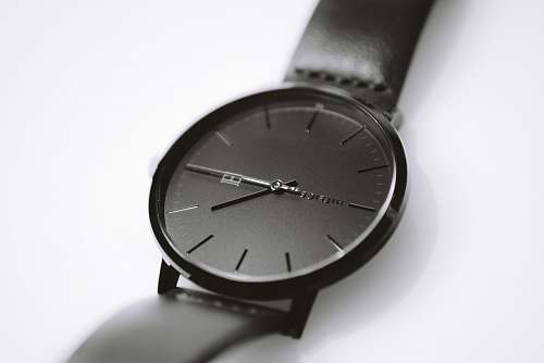grey round black analog watch wristwatch
