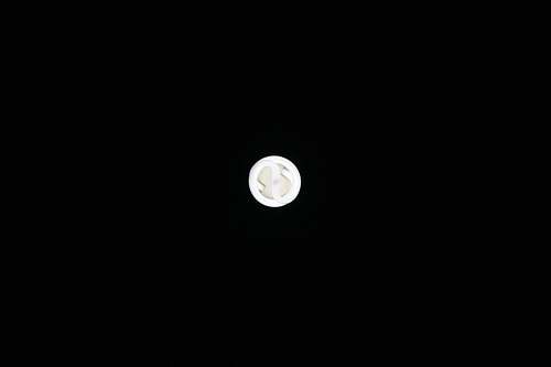 astronomy round white ornament on black surface moon