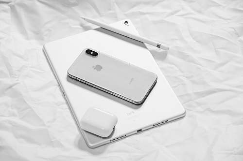 white silver iPhone X with silver iPad apple