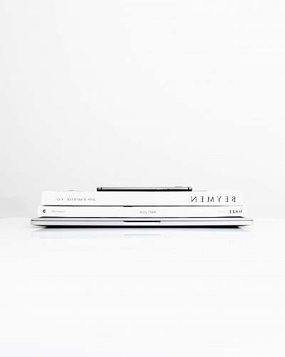 white silver laptop computer with two books on the top turkey