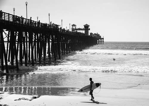 nature standing person holding surfboard outdoors