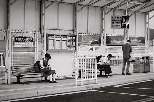 bench students sitting on bench near bus stop furniture