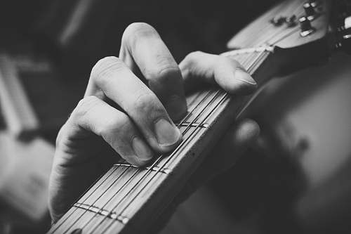 grey tilt shift photo of guitar clef music