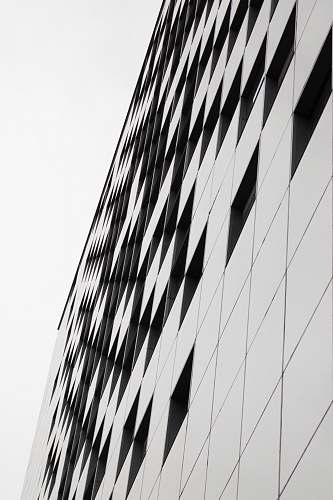 building tilt shot of gray and black building under daylight office building