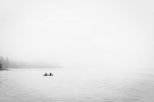 white two person in boat on body of water nature