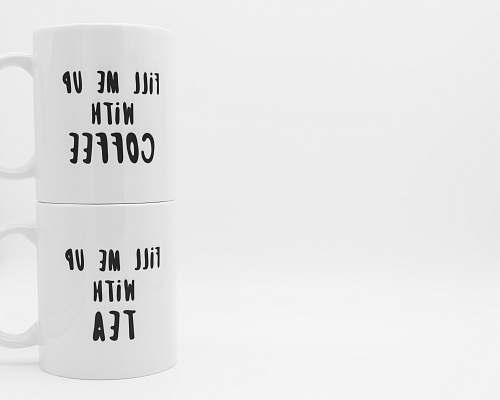 grey two white fill me up with coffee and fill me up with tea-printed ceramic mugs isolated on white background cylinder