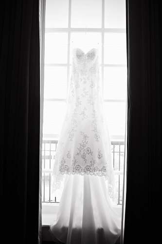white white floral wedding gown beside window wedding