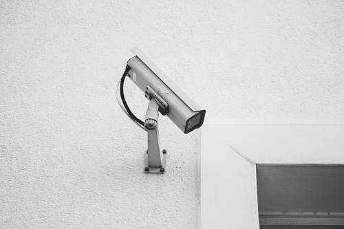 grey white security camera on white wall camera
