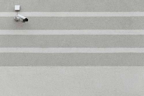 grey white surveillance camera wall