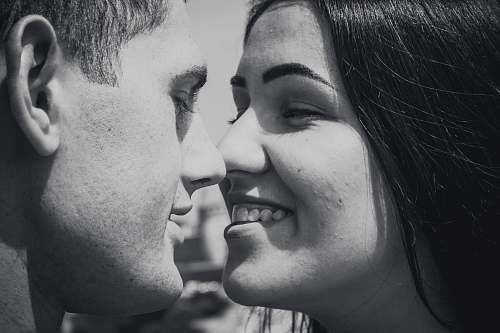 human woman and man facing each other while smiling person