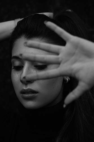 human woman covering own face person