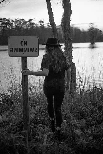 human woman holding no swimming signage person