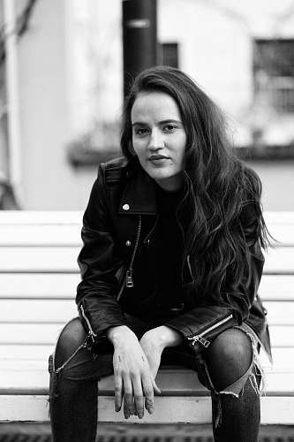 apparel woman sitting on bench outdoor clothing