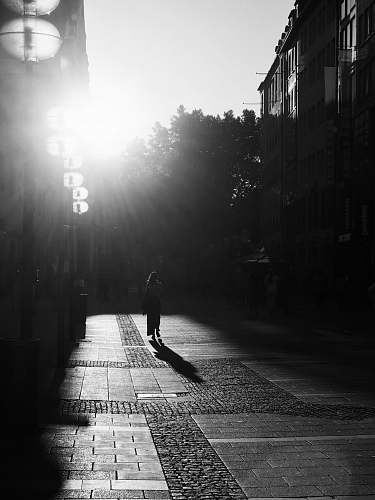 light woman walking on alley flare
