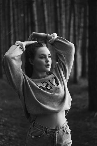 person woman with arms behind her neck near trees human