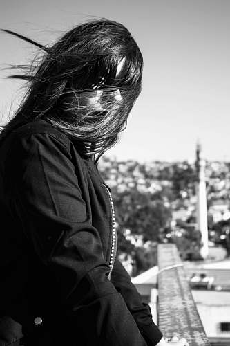 apparel woman's face covered with hair looking at her left during day clothing