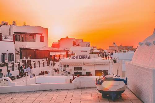 watercraft landscape photo of people walking on road during golden hour vessel