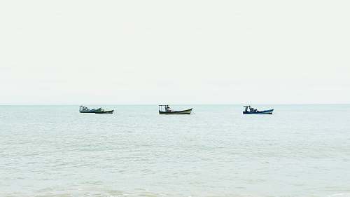 transportation three boats on body of water during daytime vehicle