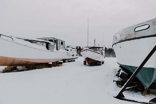snow three boats on snow ground ice