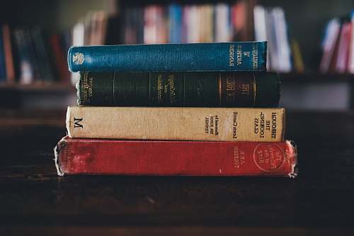 library four assorted reading books on brown surface stack