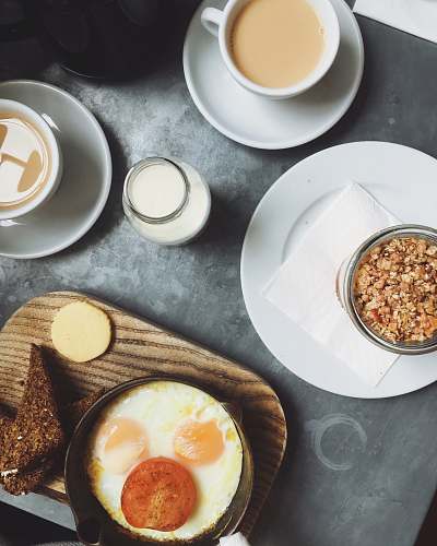 food sunny side-up egg on plate beside white plates meal