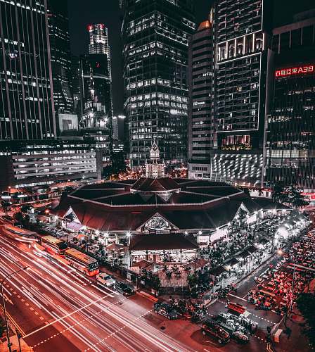 arena black and white lighted building surrounded by vehicles city