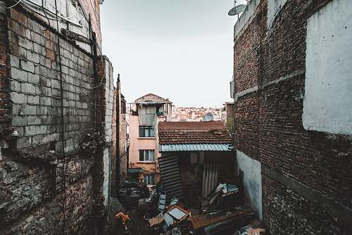city brown shed between buildings brick