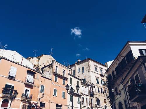 city grey and orange buildings under blue sky apartment building