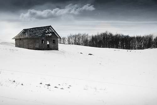 outdoors house on white snow field hut