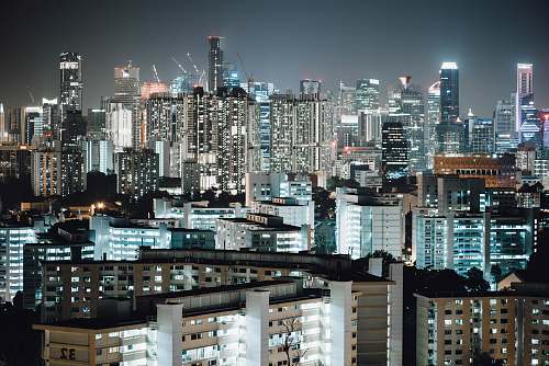 city lighted city buildings during nighttime high rise