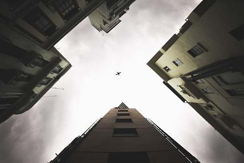 architecture low-angle photography of airplane during daytime city