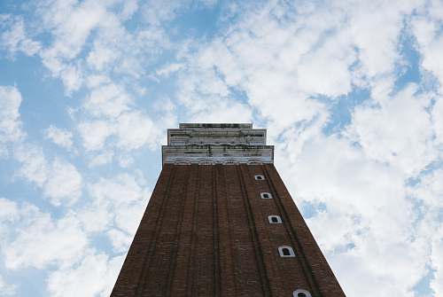 tower low angle photography of brown painted building architecture