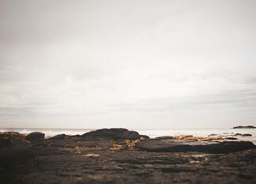 architecture low angle photography of stones on seaside nature