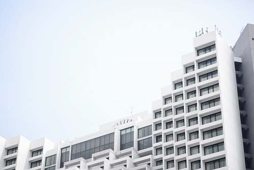 white low angle photography of white concrete building building complex