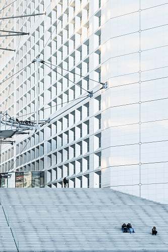 architecture man standing beside white building city