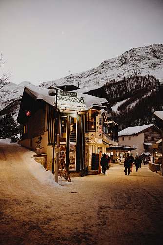 switzerland people walking beside buildings near mountain hut
