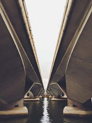 architecture two gray concrete bridge on body of water singapore